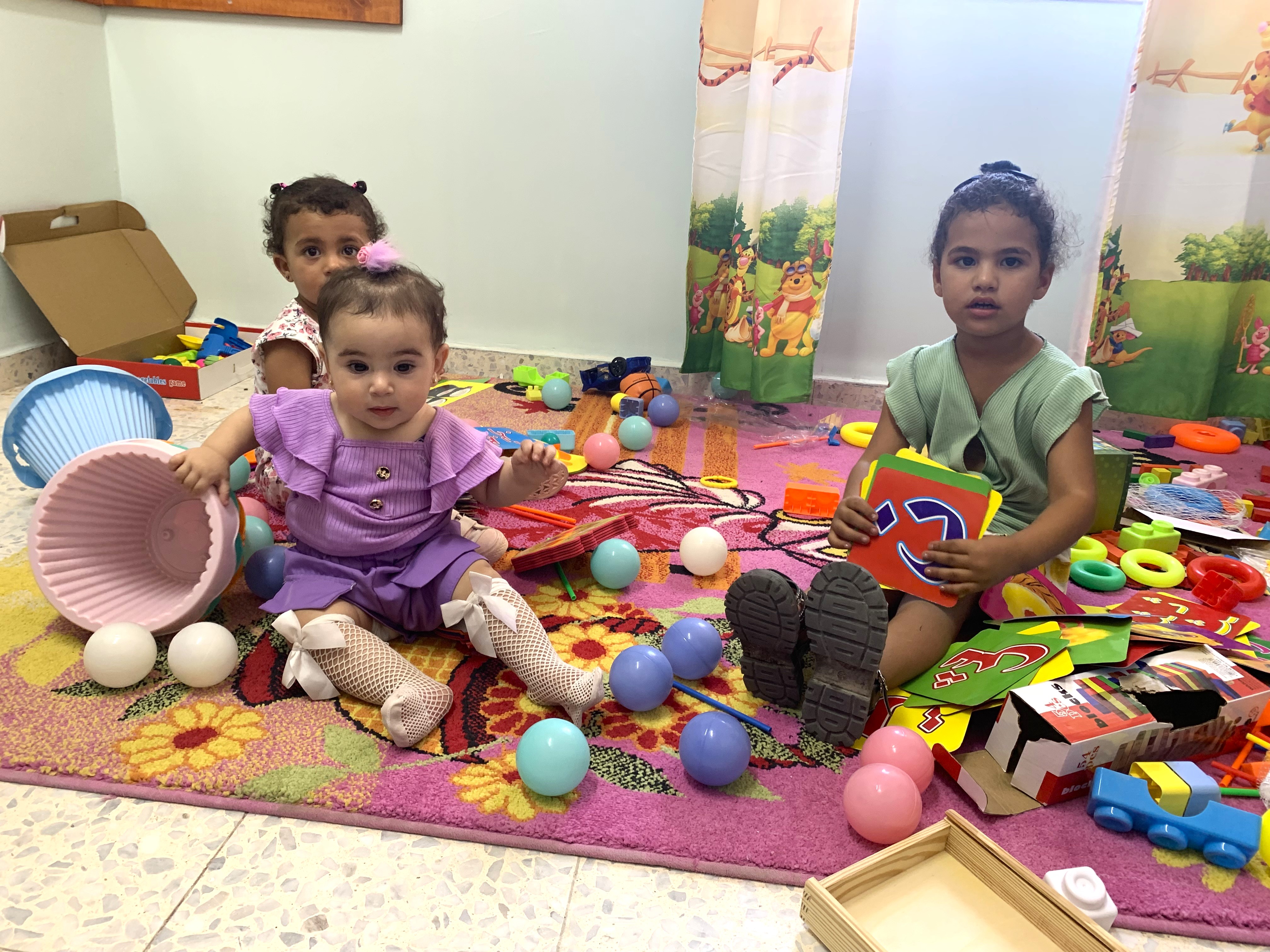 Aziza's daughter in a child-friendly corner in a health center